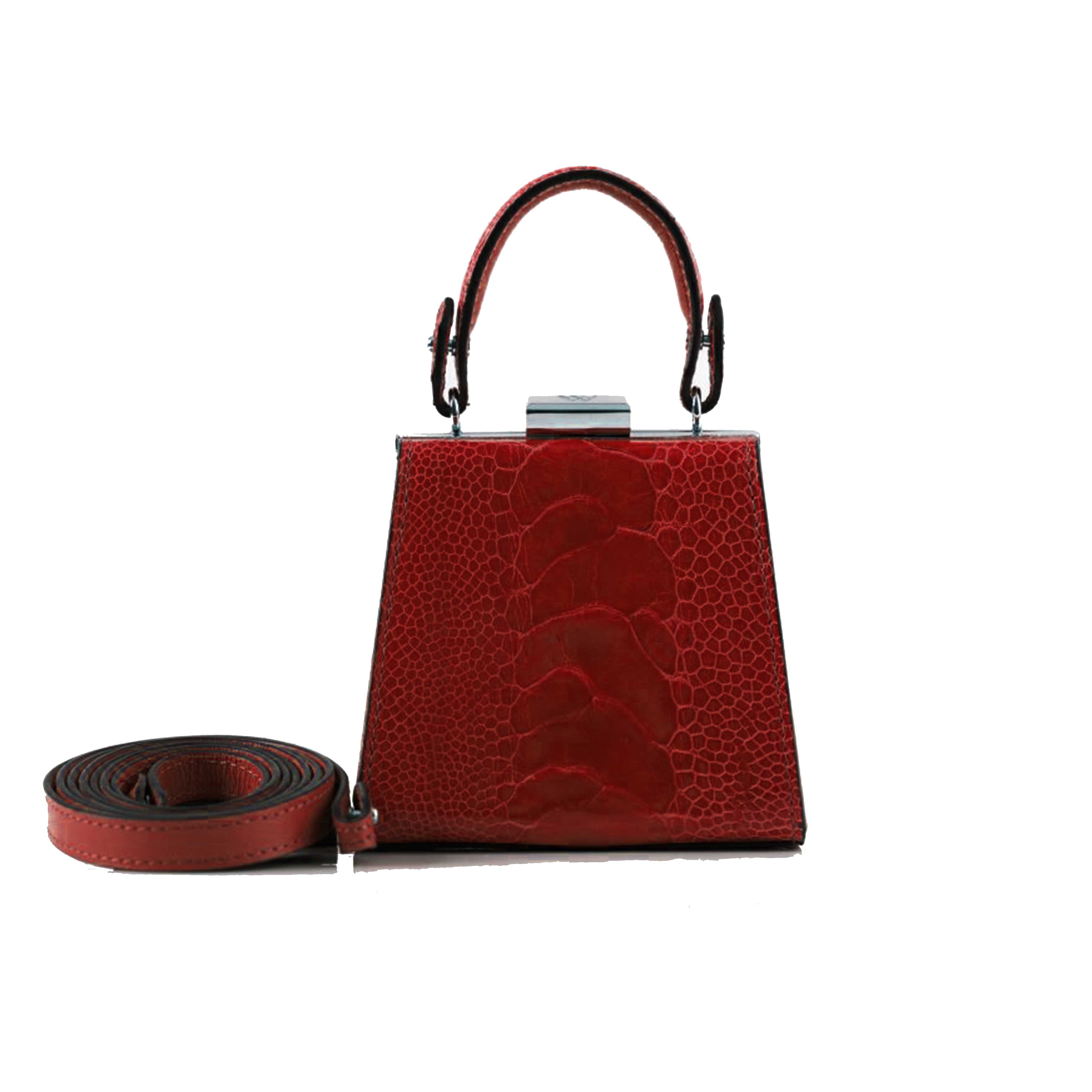 Red textured handbag with matching strap on a white background