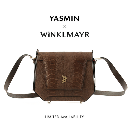 A brown marron ostrich leg leather handbag with a crocodile pattern texture, designed by Yasmin x Winklmayr. The bag has an adjustable strap, a front closure, and appears to be a limited edition.