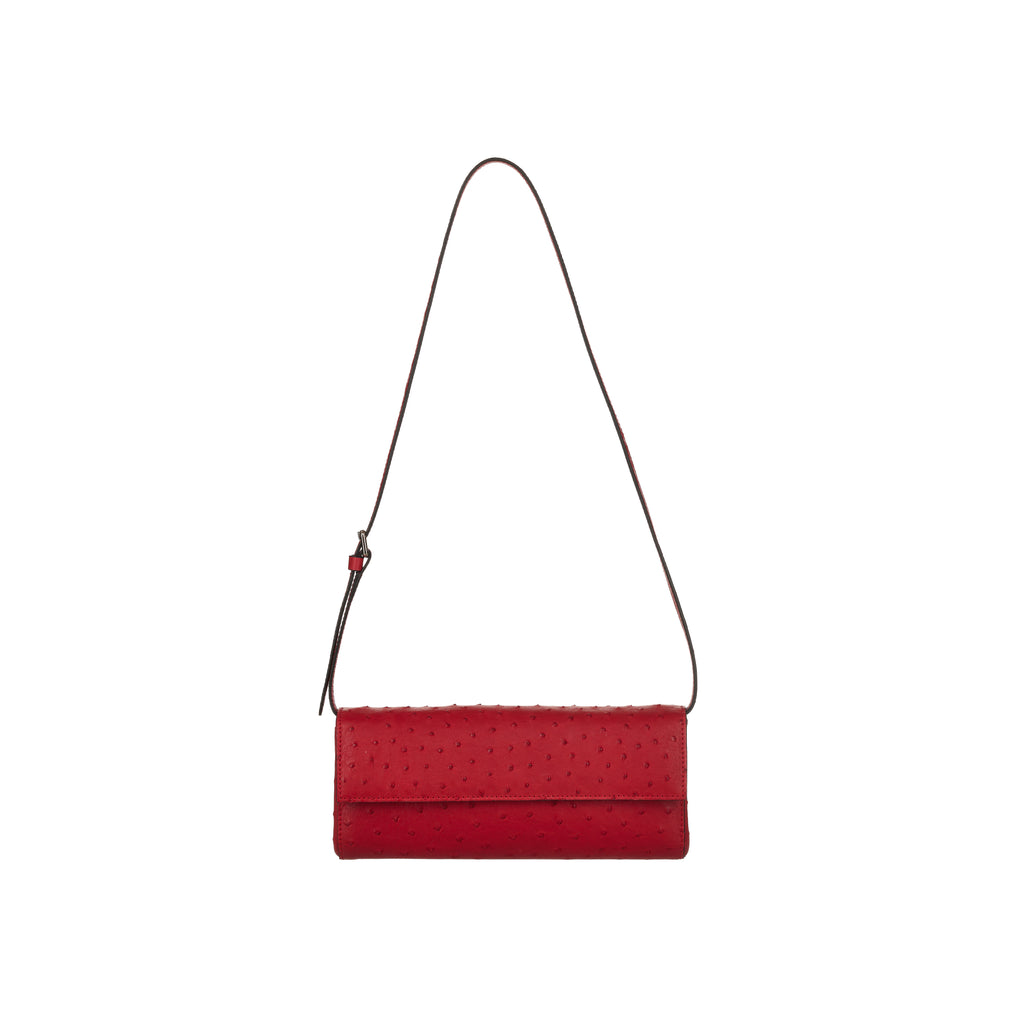 Red clutch bag with a strap on a white background