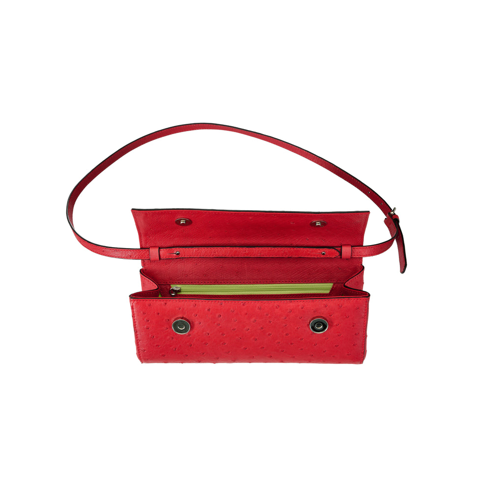 Red handbag with a strap on a white background