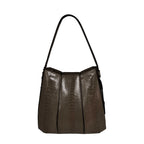 Brown textured handbag on a white background