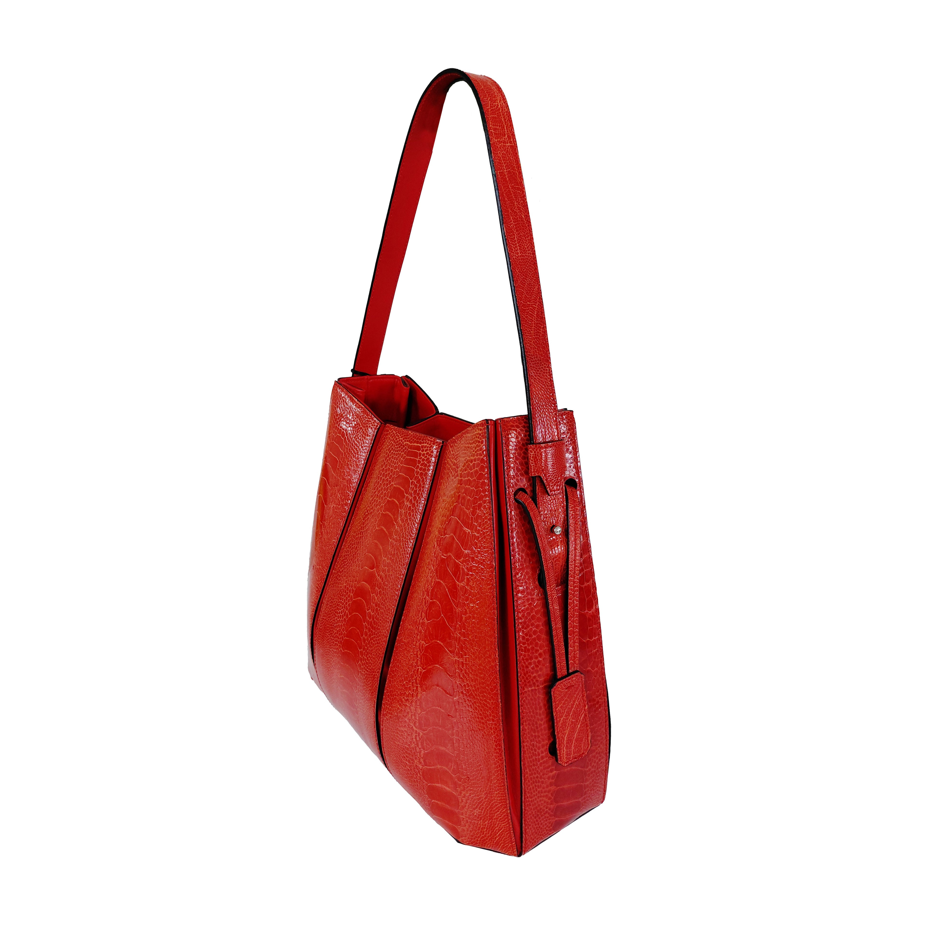 Red handbag with a textured pattern on a white background