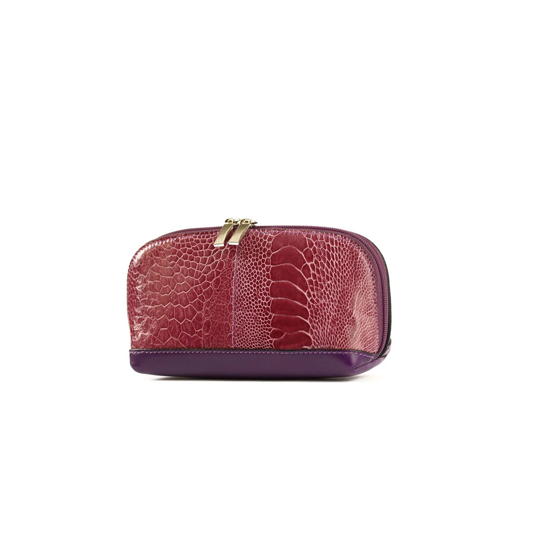 A purple cosmetics purse with a crocodile pattern and a gold-tone clasp, against a white background.