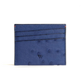 A blue card holder with multiple card slots and a small amount of cash, made from ostrich quill leather.