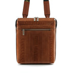 A brown premium ostrich leather satchel with a zipper pocket and a crossbody strap.