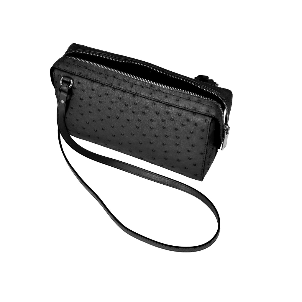 Black textured handbag with a strap on a white background