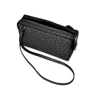 Black textured handbag with a strap on a white background