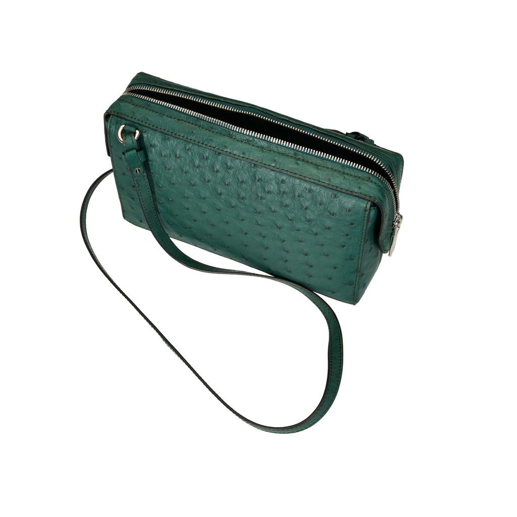 Green textured handbag with a strap on a white background