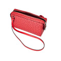 Red textured handbag with a strap on a white background