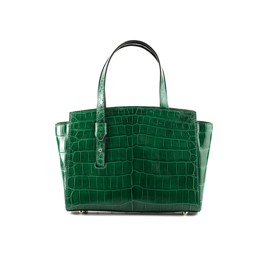 An emerald green, crocodile patterned leather handbag with a sleeve-style handle and a magnetic closure flap.
