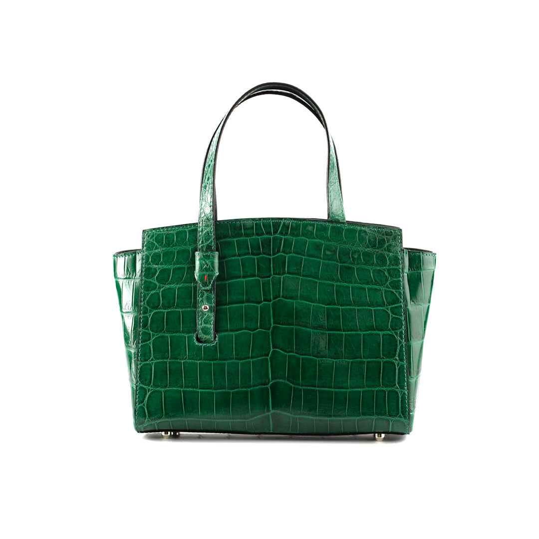 An emerald green, crocodile patterned leather handbag with a sleeve-style handle and a magnetic closure flap.