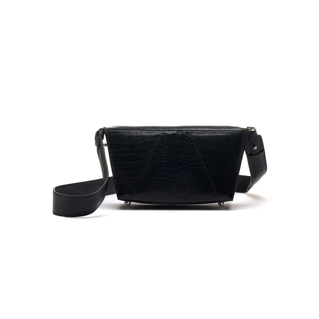 A black faux leather handbag with a structured design, featuring a removable and adjustable strap, a magnetic closure, and protective bottom studs.