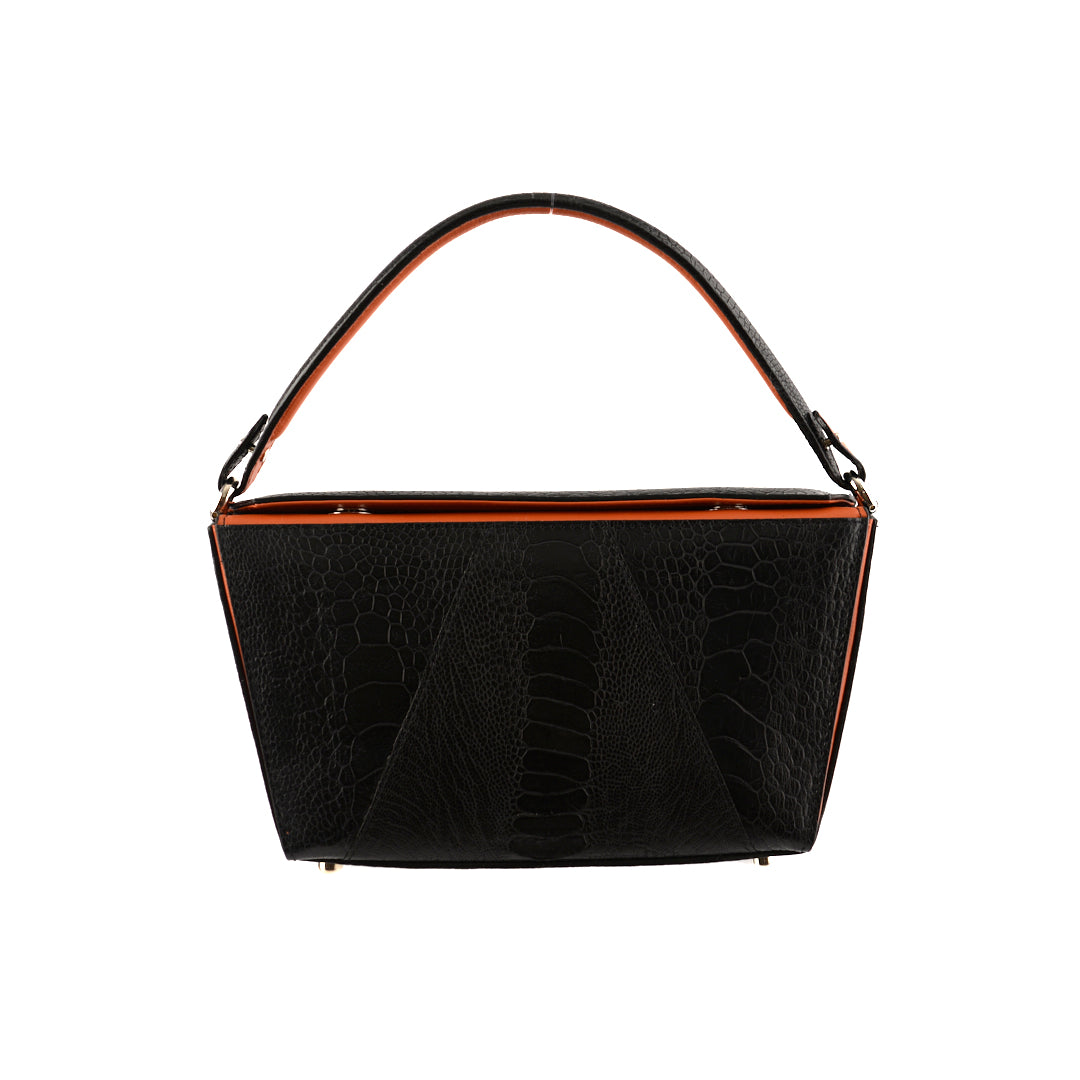A black handbag with orange gussets and a removable brown strap, featuring a sleek and minimalistic design.