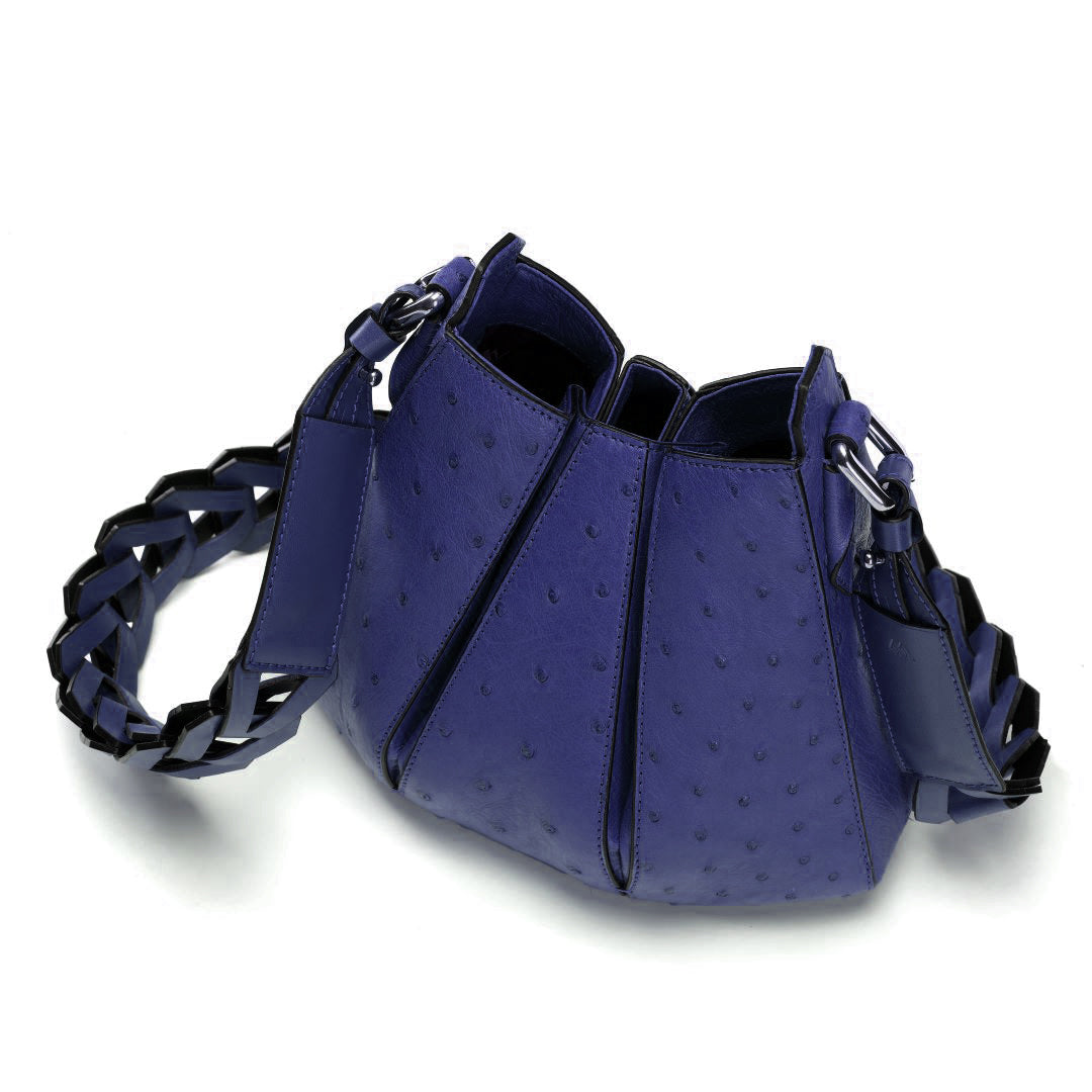 A blue ostrich-textured shoulder bag with a braided strap, shown on a white background.