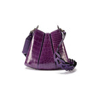 A handbag with a crocodile pattern in African Violet color with a removable and adjustable link strap.