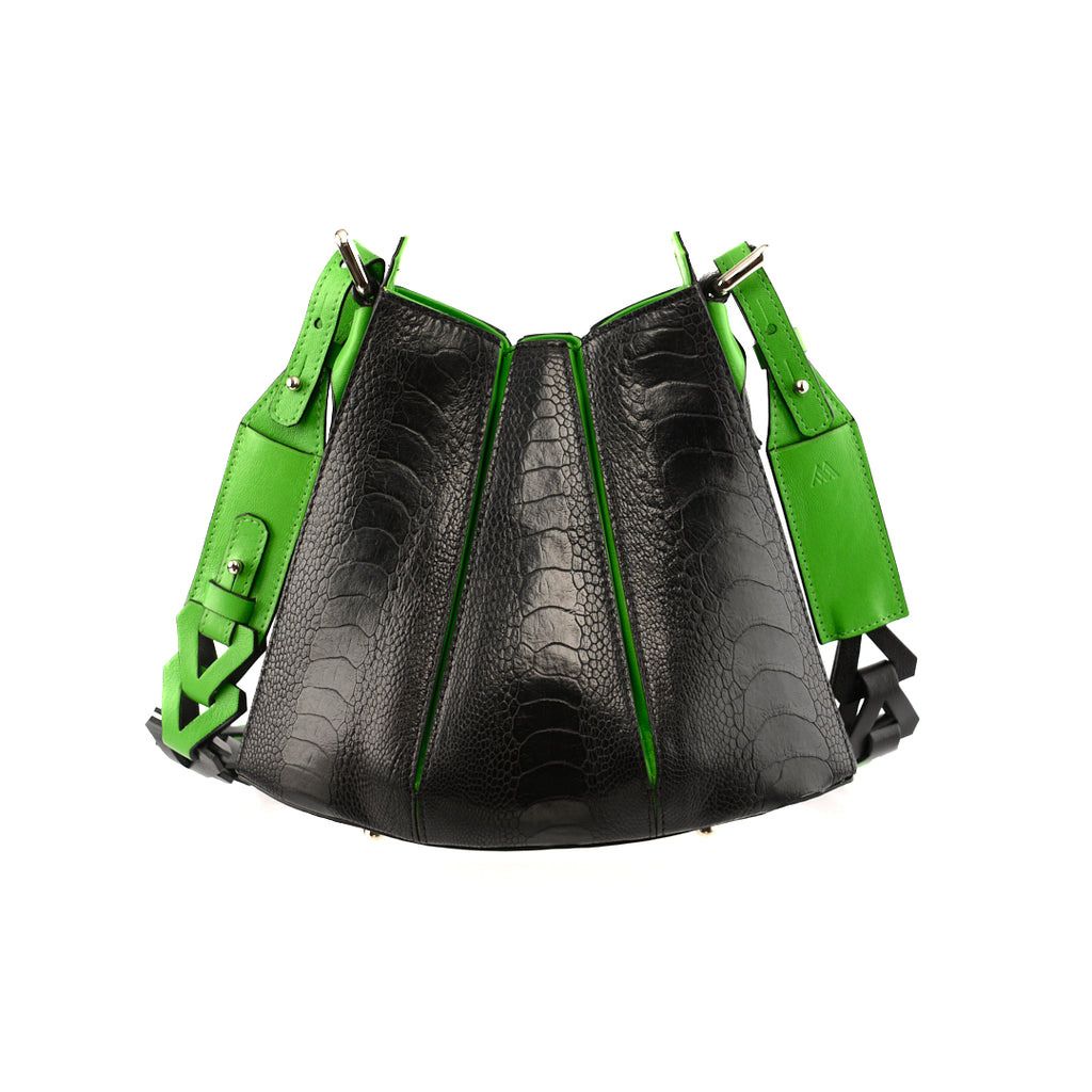 A black handbag with green gussets and adjustable straps, featuring a tulip closure design.