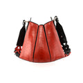 A red handbag with black gussets, featuring a tulip closure design, with a removable link strap.