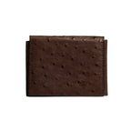 A brown, leather trifold wallet with raised dot pattern and a slip pocket.