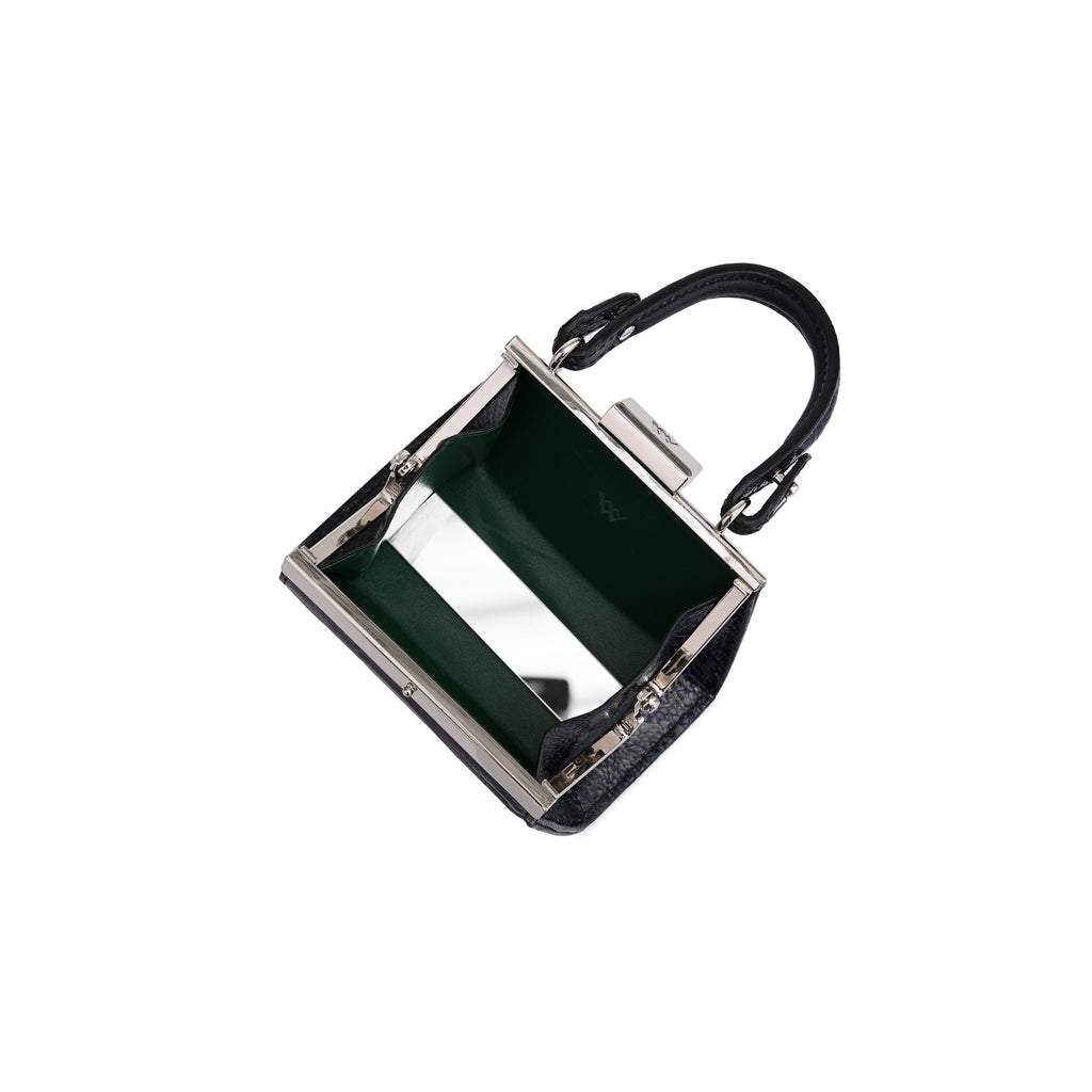 A small structured handbag with a dark green interior lining, a black top handle, and a silver-tone metal frame, shown on a plain white background.