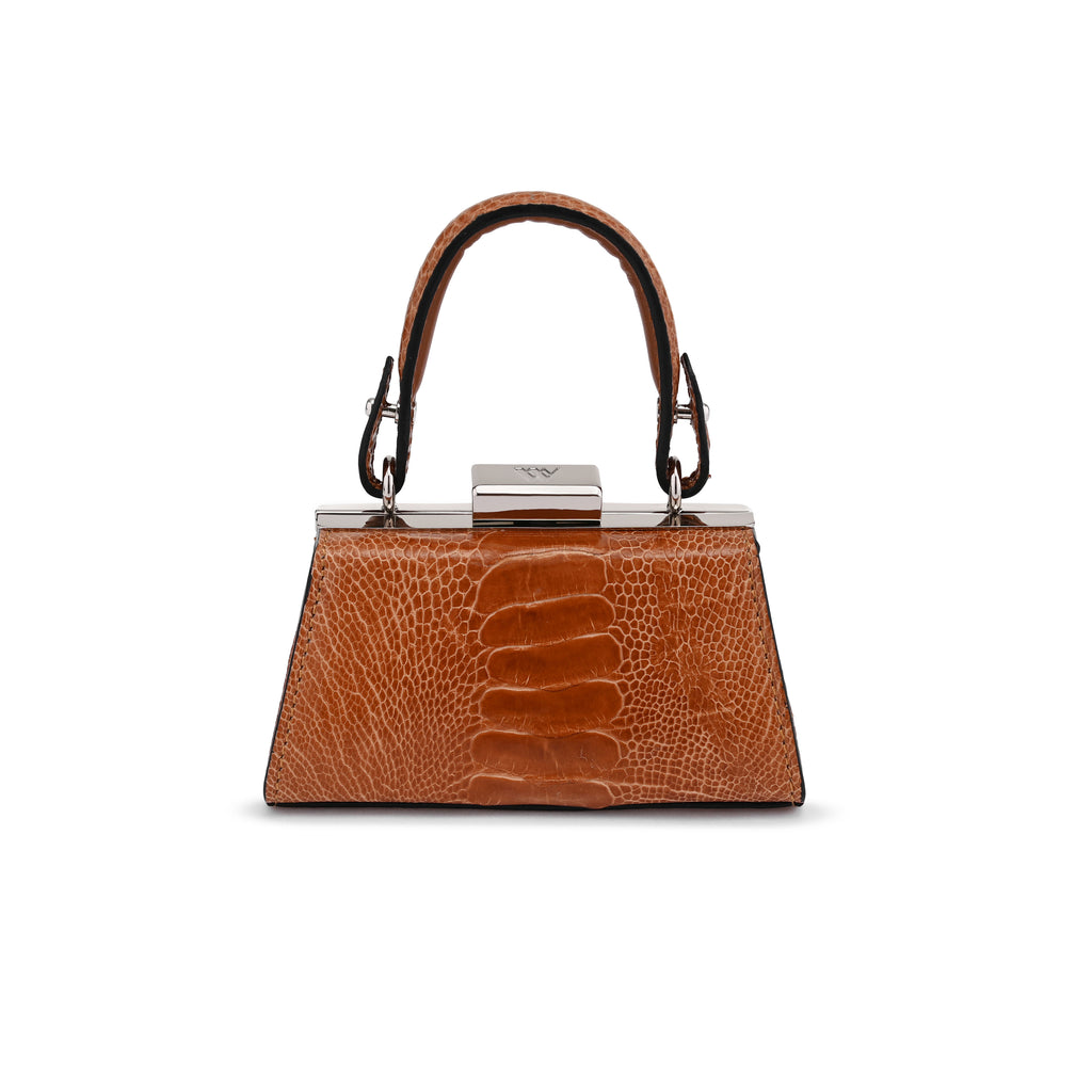 A structured brown handbag with a crocodile-embossed texture, featuring a top handle, silver-tone hardware, and a central clasp, shown against a plain white background.