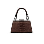 A structured dark brown handbag with a textured crocodile skin pattern, featuring a top handle, silver-tone hardware, and a central clasp with a small logo, set against a plain white background.
