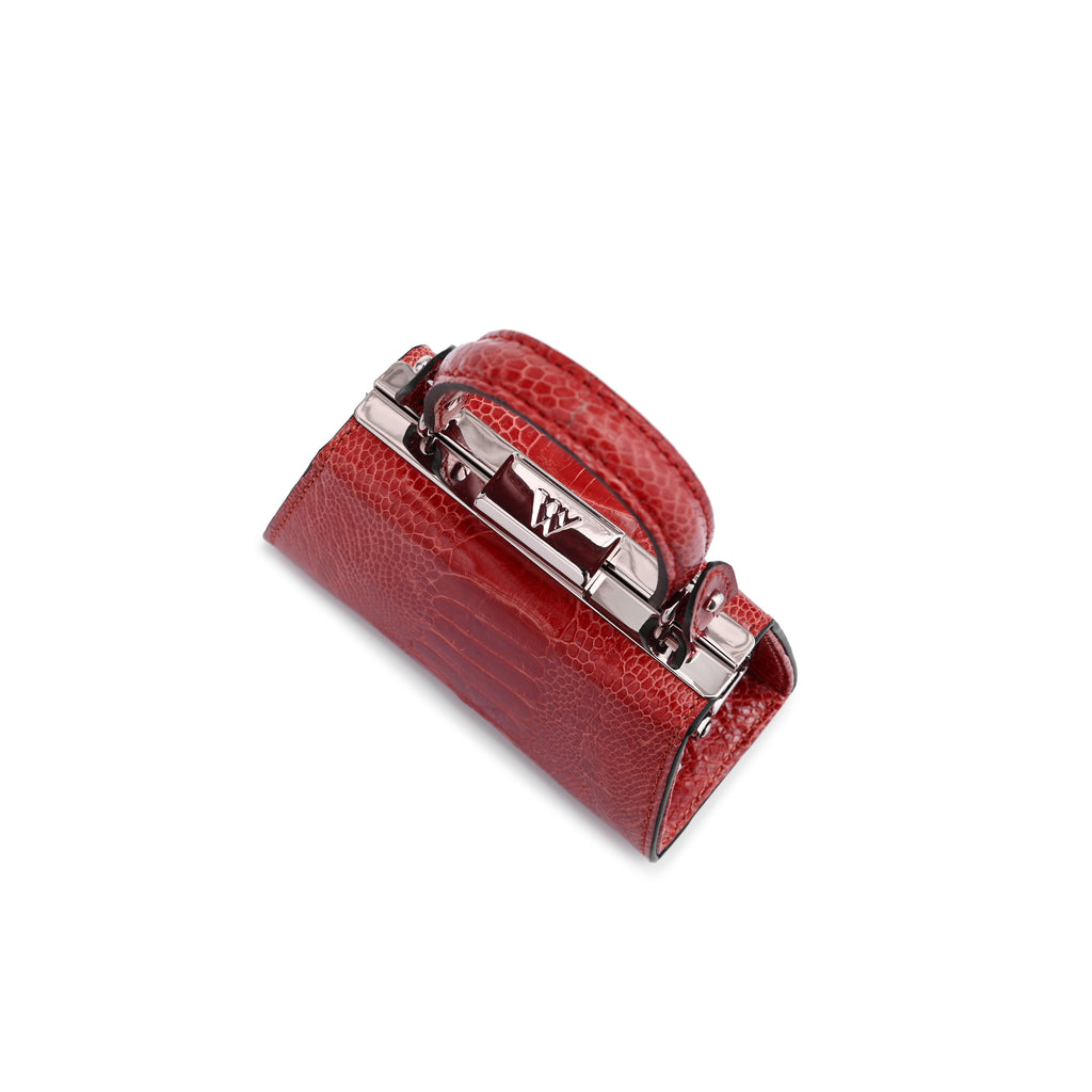 A small red textured leather clutch bag with silver-tone hardware and a turn-lock clasp, shown on a plain white background.