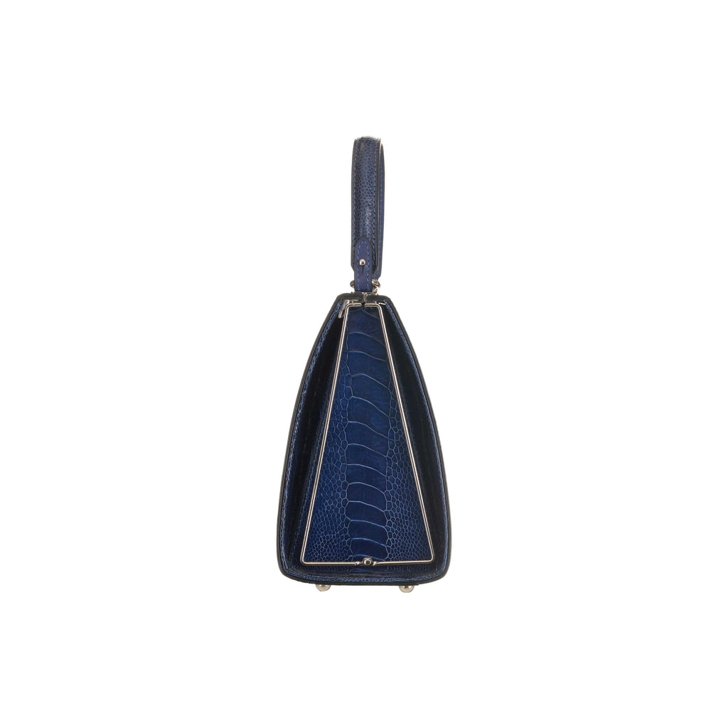 Blue handbag with a distinctive pattern on a white background