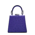Purple handbag with a textured surface on a white background