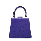 Purple handbag with a textured surface on a white background