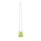 A lime green textured leather crossbody bag with a long thin black shoulder strap, shown against a plain white background.