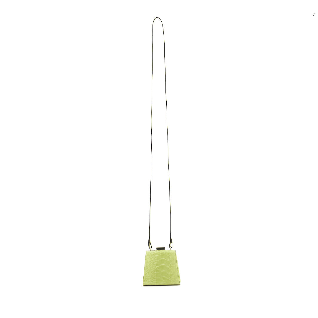 A lime green textured leather crossbody bag with a long thin black shoulder strap, shown against a plain white background.