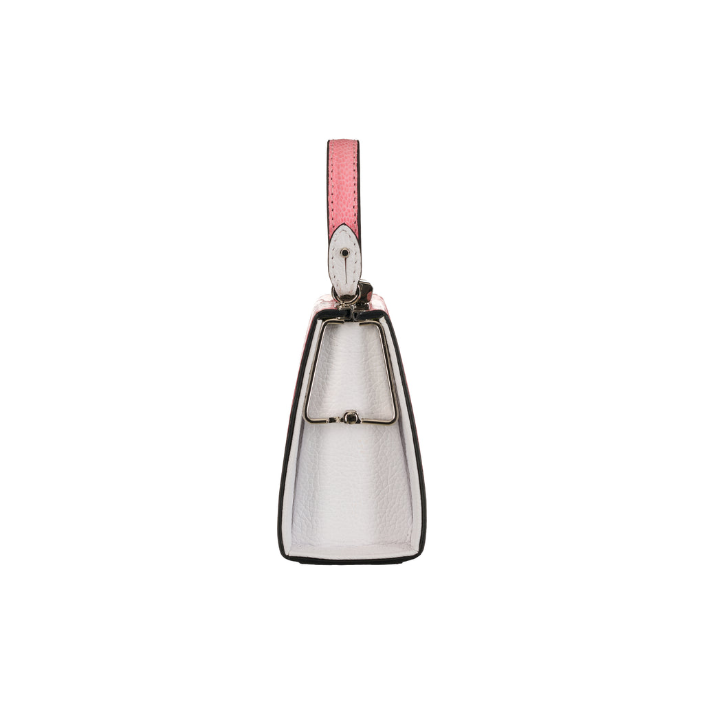 Silver cowbell with a pink strap on a white background