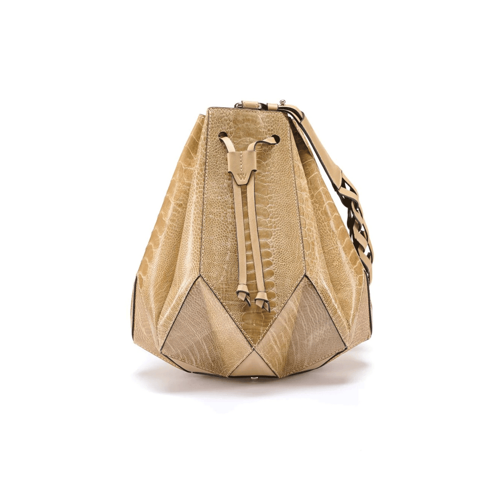 A beige and brown leather handbag with a geometric design and a drawstring top closure, resembling a star.