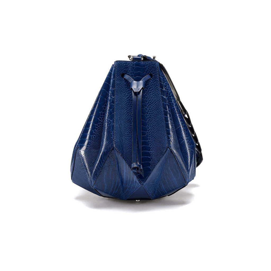 A blue handbag with a unique drawstring bucket design and an eight pointed star base, resembling a star shape.