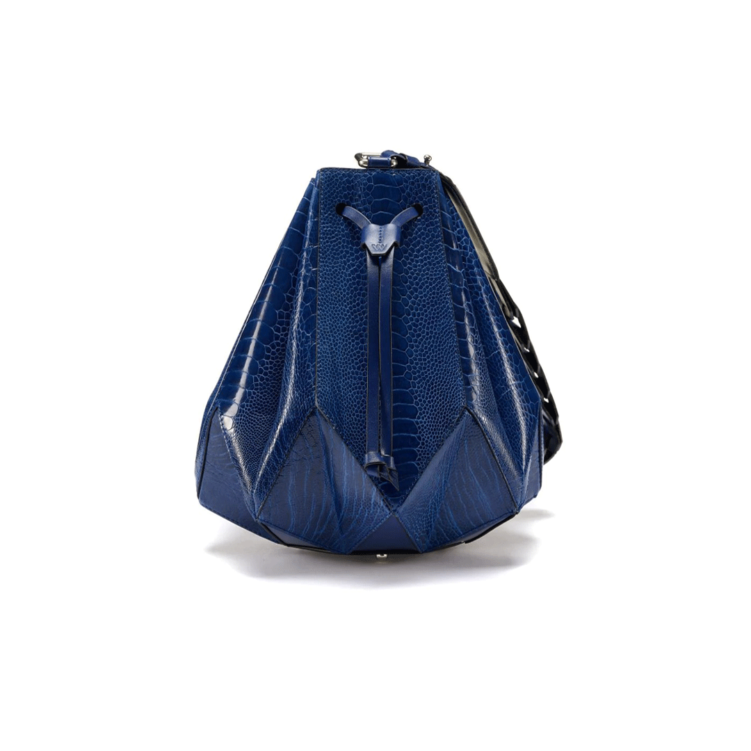 A blue handbag with a unique drawstring bucket design and an eight pointed star base, resembling a star shape.