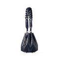Blue handbag with braided handle on a white background
