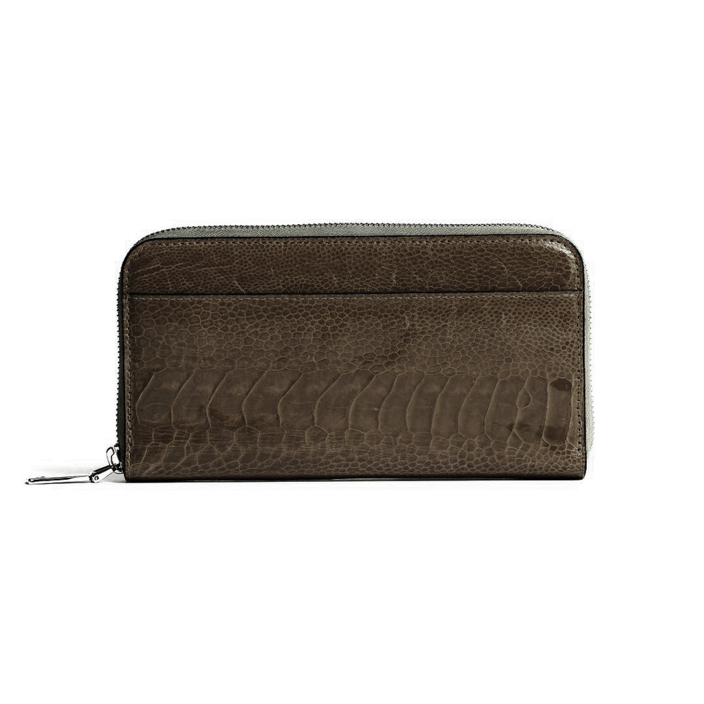 A dark brown zip-around wallet with a textured crocodile skin pattern, shown against a plain white background.