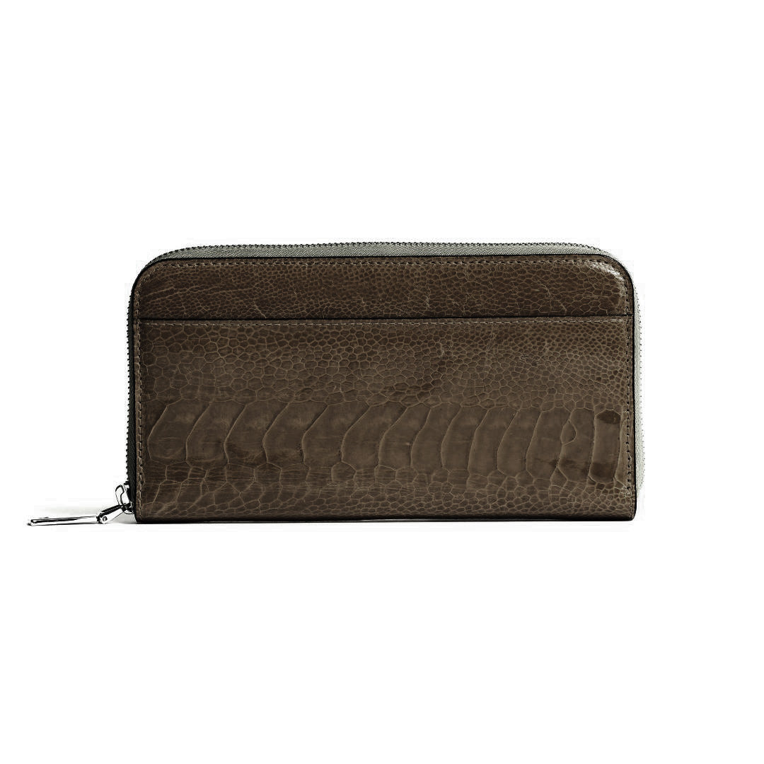A dark brown zip-around wallet with a textured crocodile skin pattern, shown against a plain white background.