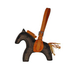 Horse-shaped keychain with brown leather strap and fringes on a white background